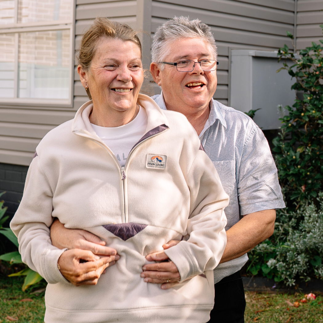 Kristine and her partner standing outside smiling