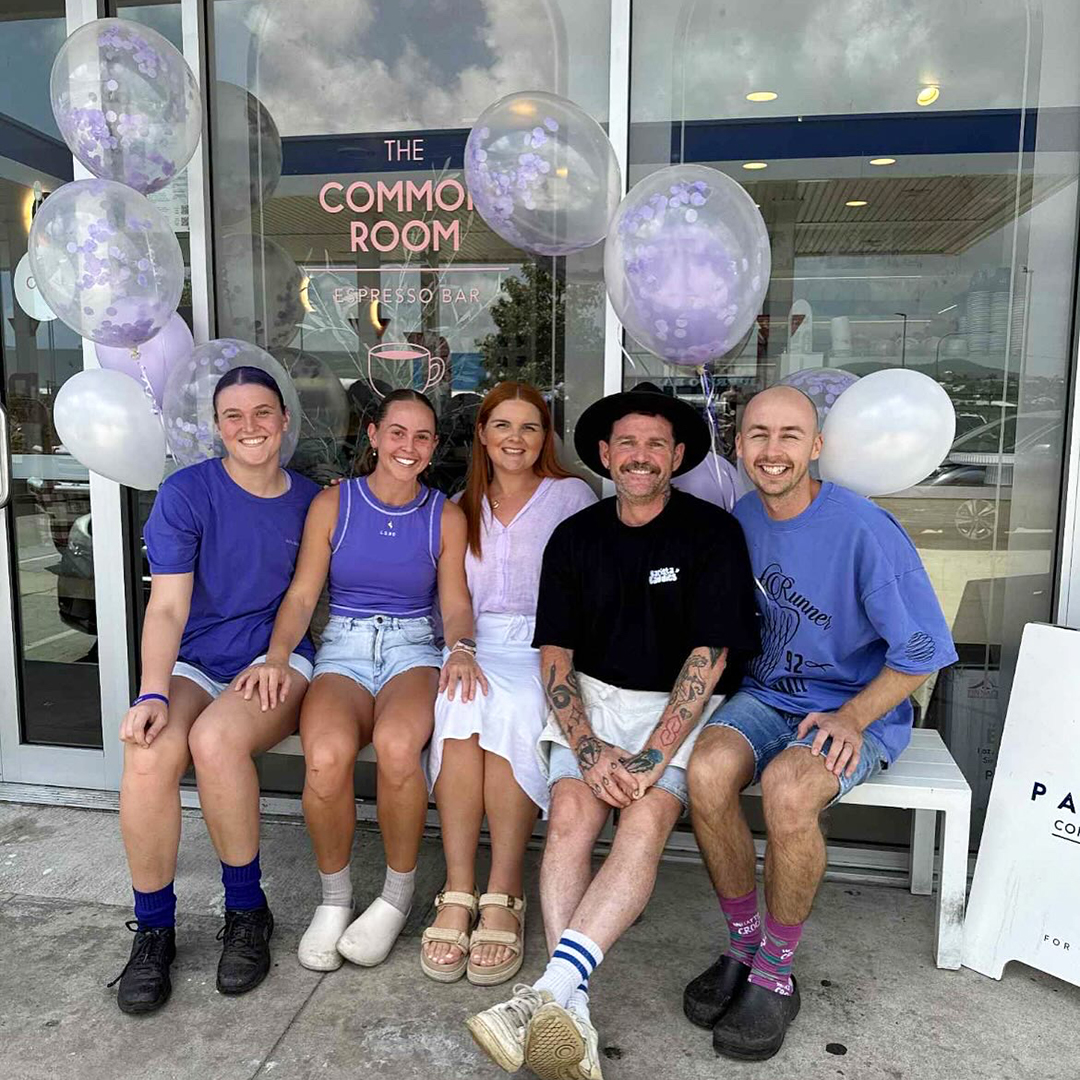 Five people sitting outside on a bench at a venue hosting a Cuppatime for Dementia event.